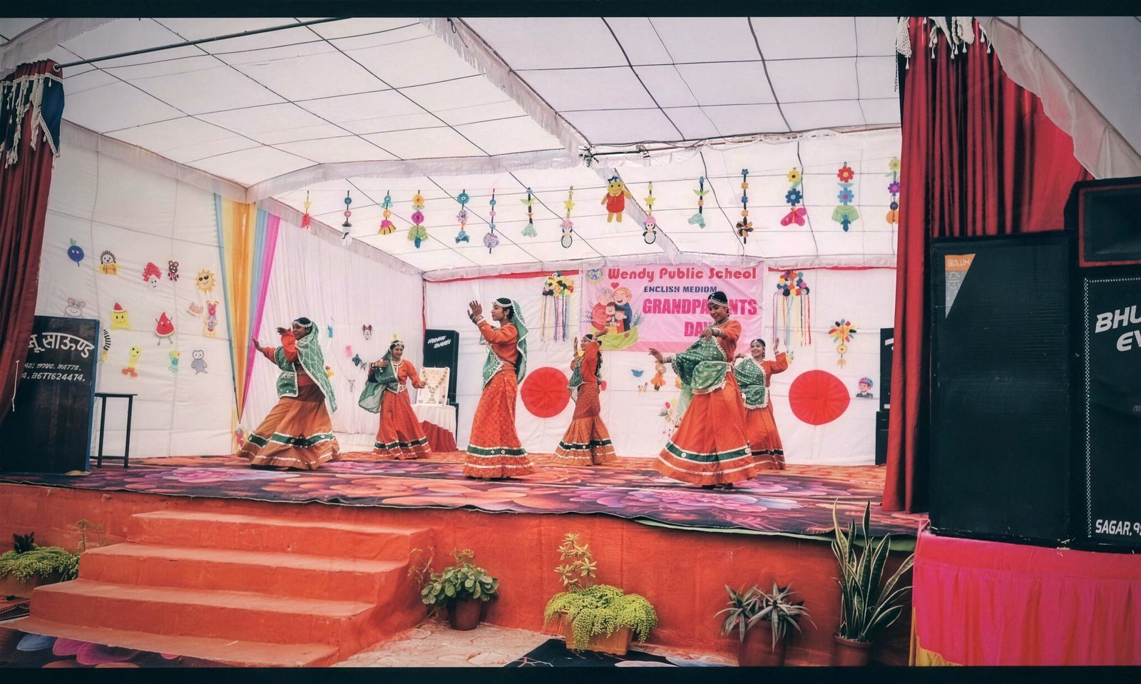 Students in costume performing a dance at a school celebration